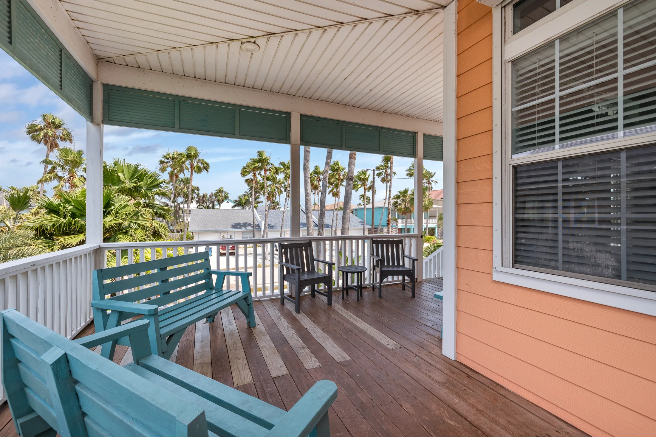 Covered porch seating at Beach Breeze SPI