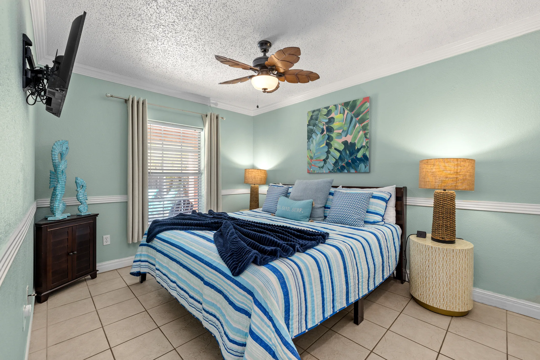 Bedroom 3 king bed with striped blue bedding and seahorse decor